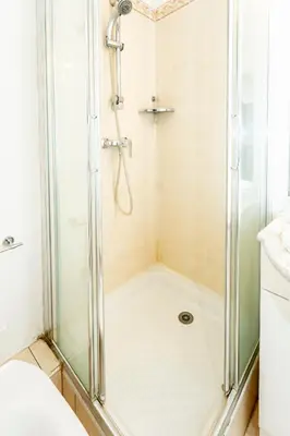 a shower with a glass door in a bathroom at Palais Magnan 4 Pers WiFi AC in Nice