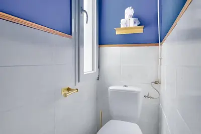 a bathroom with a toilet and a window at Lovely 1 BR Flat in the heart of Nice in Nice