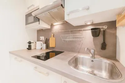 a kitchen with a sink and a counter top at Cassini 2 Pers Hyper Center WiFi in Nice