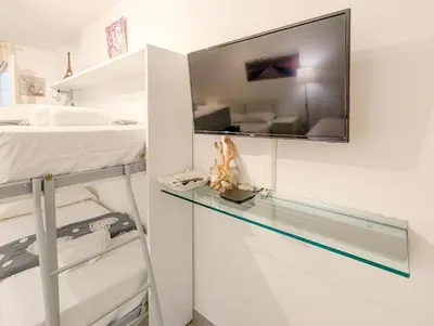 a bedroom with a bed and a tv on a wall at Chateau 4 Pers Vecchia Nizza AC WiFi in Nice
