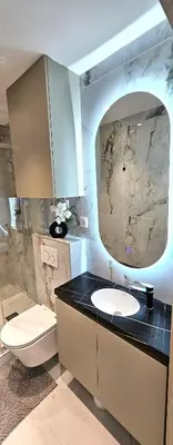 a bathroom with a sink and a toilet and a mirror at Studio Nice Plage Luxe in Nice