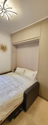 a large bed in a room with a ceiling at Studio Nice Plage Luxe in Nice