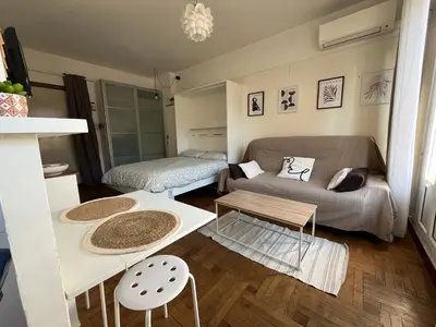 a living room with a couch and a table at Studio with large terrace sea view 4th floor in Nice