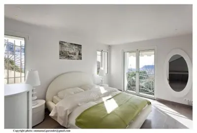 a white bedroom with a large bed and windows at MONT BORON - NICE - Splendide villa d'architecte vue panoramique in Nice