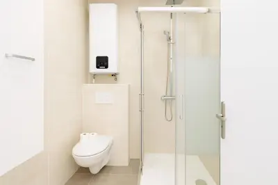 a bathroom with a toilet and a glass shower at Stella Monte 2 AC WiFi 2 Pers in Nice