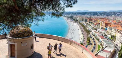 a group of people walking on a sidewalk next to the ocean at Stella Monte 3 AC WiFi 2 Pers in Nice