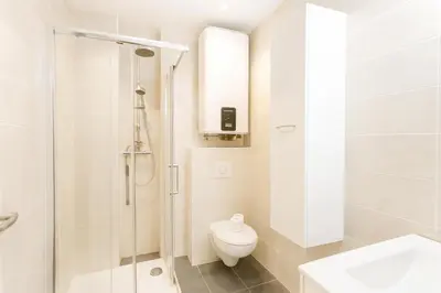 a white bathroom with a toilet and a shower at Stella Monte 3 AC WiFi 2 Pers in Nice
