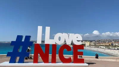 a sign with the words love nife in front of a beach at Stella Monte 3 AC WiFi 2 Pers in Nice