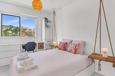 a bedroom with a swing bed and a window at Bel appartement vue mer proche de la promenade des anglais in Nice