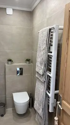 a bathroom with a toilet and towels on a rack at Le Félix in Nice