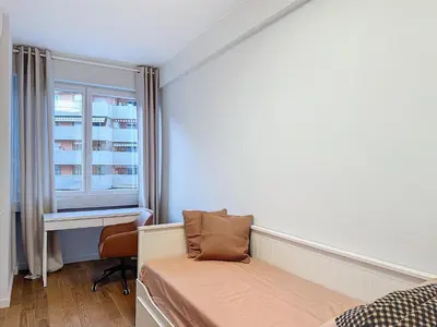 a bedroom with a bed and a desk and a window at Seaview Promenade des Anglais 2brs apartment Parking cars 1800 kg max in Nice