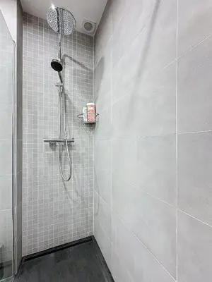 a bathroom with a shower with white tile walls at Seaview Promenade des Anglais 2brs apartment Parking cars 1800 kg max in Nice