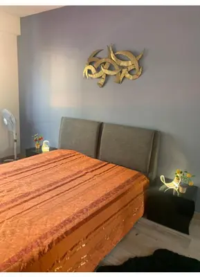 a bedroom with a wooden bed with a antlers on the wall at Nice promenade des anglais vue mer in Nice