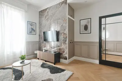 a living room with a table and a tv on a wall at #6 1BDR Buffa 2 min from the beach and Negresco,central AC Balcony in Nice