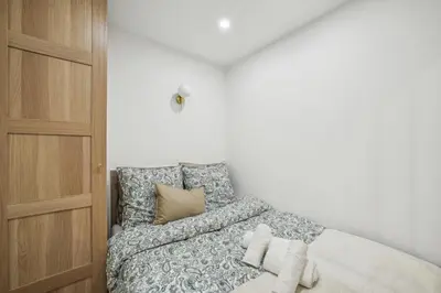 a bedroom with a bed and a wooden cabinet at Lavie Maison Hot Tub and AC in Nice