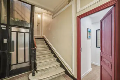 a staircase in a house with a red door at Lavie Maison Hot Tub and AC in Nice