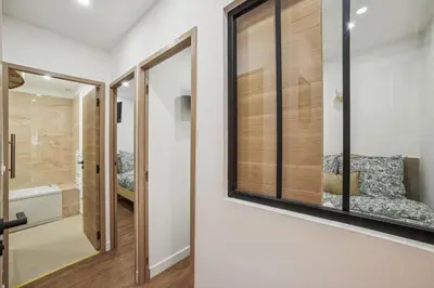 a bathroom with a glass door and a mirror at Lavie Maison Hot Tub and AC in Nice