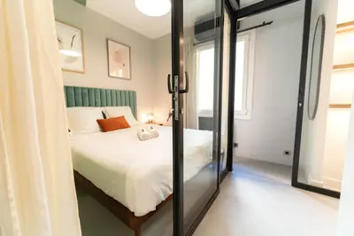 a bedroom with a bed and a large mirror at Old Town Diamond, adorable sunny apartment with AC in Nice