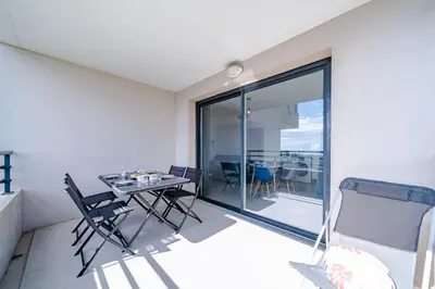 a dining room with a table and chairs on a balcony at Magnifique 4 pers,Clim,parking in Nice