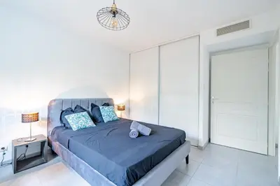 a bedroom with a large bed with a blue comforter at Magnifique 4 pers,Clim,parking in Nice