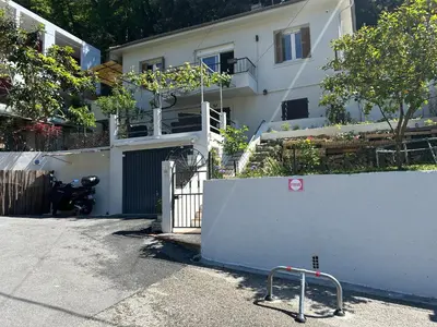 a white house with a gate and a fence at Studio climatisé avec terrasse ombragée dans maison au calme et dans la verdure in Nice