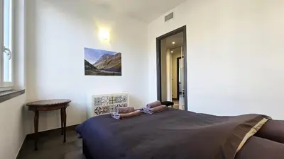 a bedroom with a bed in a room with a table at 