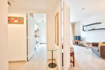 a living room with a couch and a table at 2P balcon Vue Mer YourHostHelper 2 mins de la mer in Nice