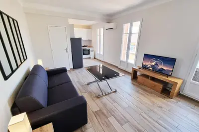 a living room with a black couch and a tv at 