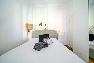 a white bedroom with a large white bed at Charmant 2P au cœur de Nice in Nice