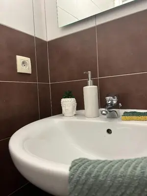 a bathroom with a white sink and a mirror at blue sun in Nice