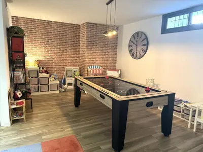 a ping pong table in a room with a clock at Villa moderne pour 8 personnes - Vue sur Nice ! in Nice