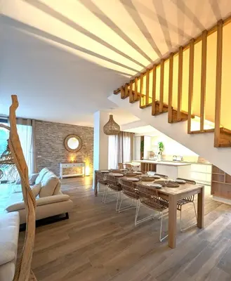 a living room with a long table and chairs at Villa moderne pour 8 personnes - Vue sur Nice ! in Nice