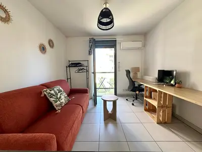 a living room with a red couch and a desk at Studio 600 m de la Promenade des Anglais in Nice