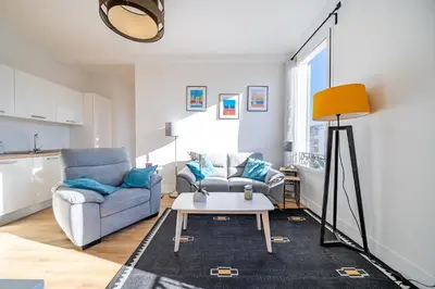 a living room with a couch and a table at Cosy 3P en plein cœur de Nice in Nice