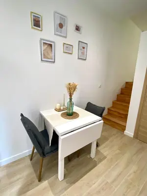 a white dining room with a white table and chairs at Studio cosy Nice in Nice