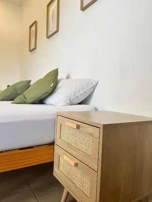 a bedroom with a bed and a table with a drawer at Terrasse, piscine, clim, proche aéroport et plage in Saint-Laurent-du-Var