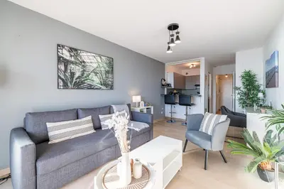 a living room with a couch and a table at Sea View & Promenade des Anglais Studio in Nice