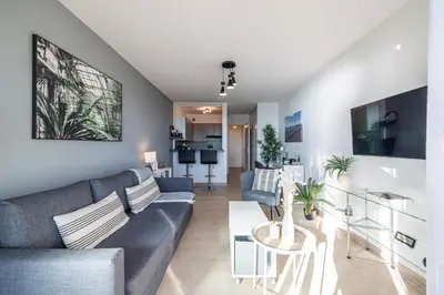 a living room with a couch and a table at Sea View & Promenade des Anglais Studio in Nice
