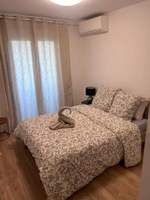 a bedroom with a bed with a snake on it at Olympie, airport, train and tram station Fully equipped for 3 peoples in Nice