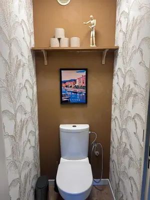 a bathroom with a toilet with a picture on the wall at Olympie, airport, train and tram station Fully equipped for 3 peoples in Nice