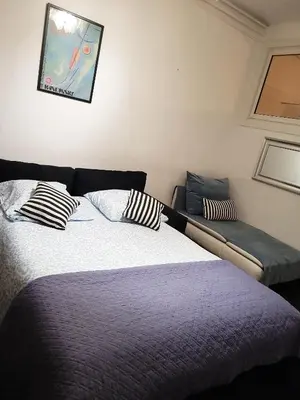 a bedroom with a bed with a pillow on it at Appartement à 2 pas de la Promenade des Anglais vue mer 7 avenue de Fabron in Nice