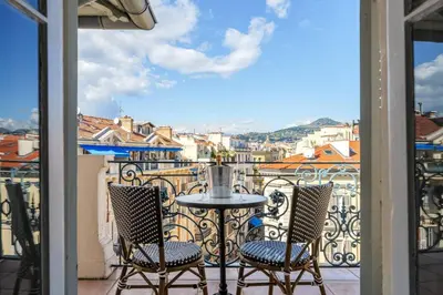 a table and two chairs on a balcony with a view at Perchoir au coeur de Nice in Nice