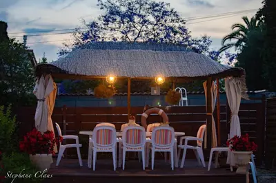 a table and chairs in front of a gazebo at Rez de Jardin Villa Cagnes Sur Mer. in Cagnes-sur-Mer