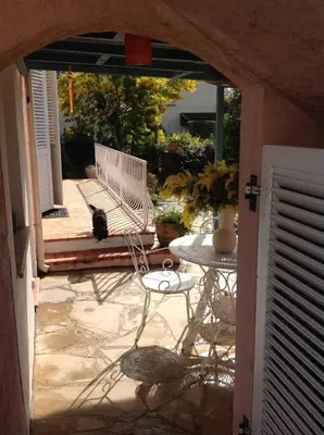 a view of a patio with a bench and a table at Rez de Jardin Villa Cagnes Sur Mer. in Cagnes-sur-Mer
