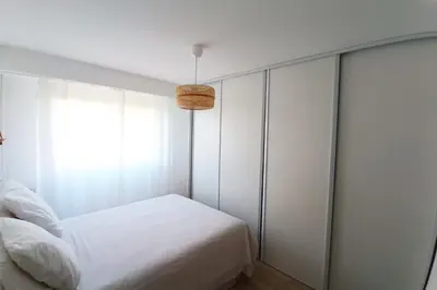 a bedroom with a white bed and a window at 2-rooms apartment with Wifi and balcony in Nice