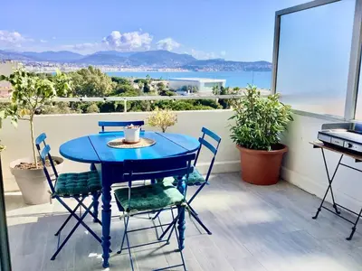 a blue table and chairs on a balcony at Nice Excepetional view in Nice