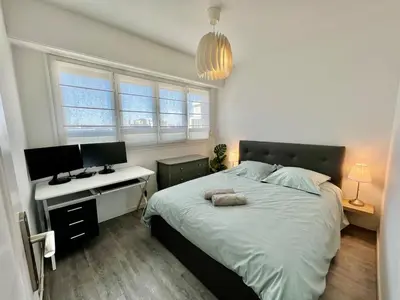 a bedroom with a bed and a desk with a computer at Nice Excepetional view in Nice