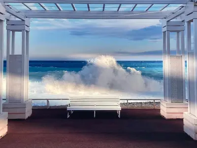 a white bench sitting in front of the ocean at Nice Excepetional view in Nice