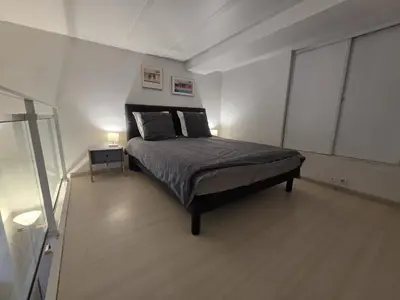 a bedroom with a bed with two lamps on it at Carré d'Or Star Loft in Nice