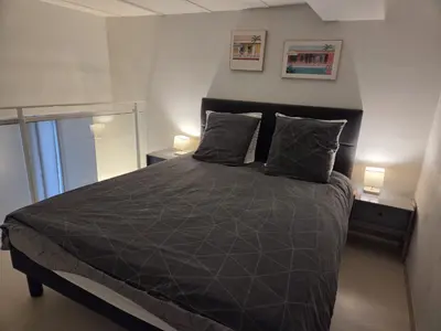 a bedroom with a bed with a black comforter at Carré d'Or Star Loft in Nice